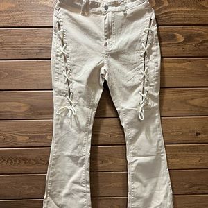 NWT Tan lightweight jeans with cut out on legs and ties. Size Medium. Very cute